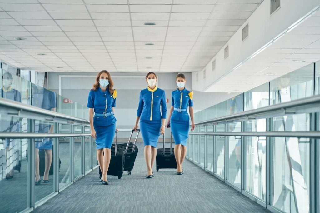 Flight Attendants In California Walking Through An Airport.